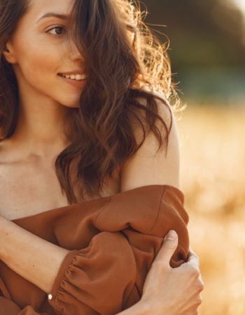 woman-summer-field-brunette-brown-sweater 2
